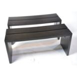 A pair of designer ebonised benches.