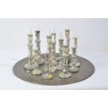 Twelve assorted candlesticks on Indian style tray.
