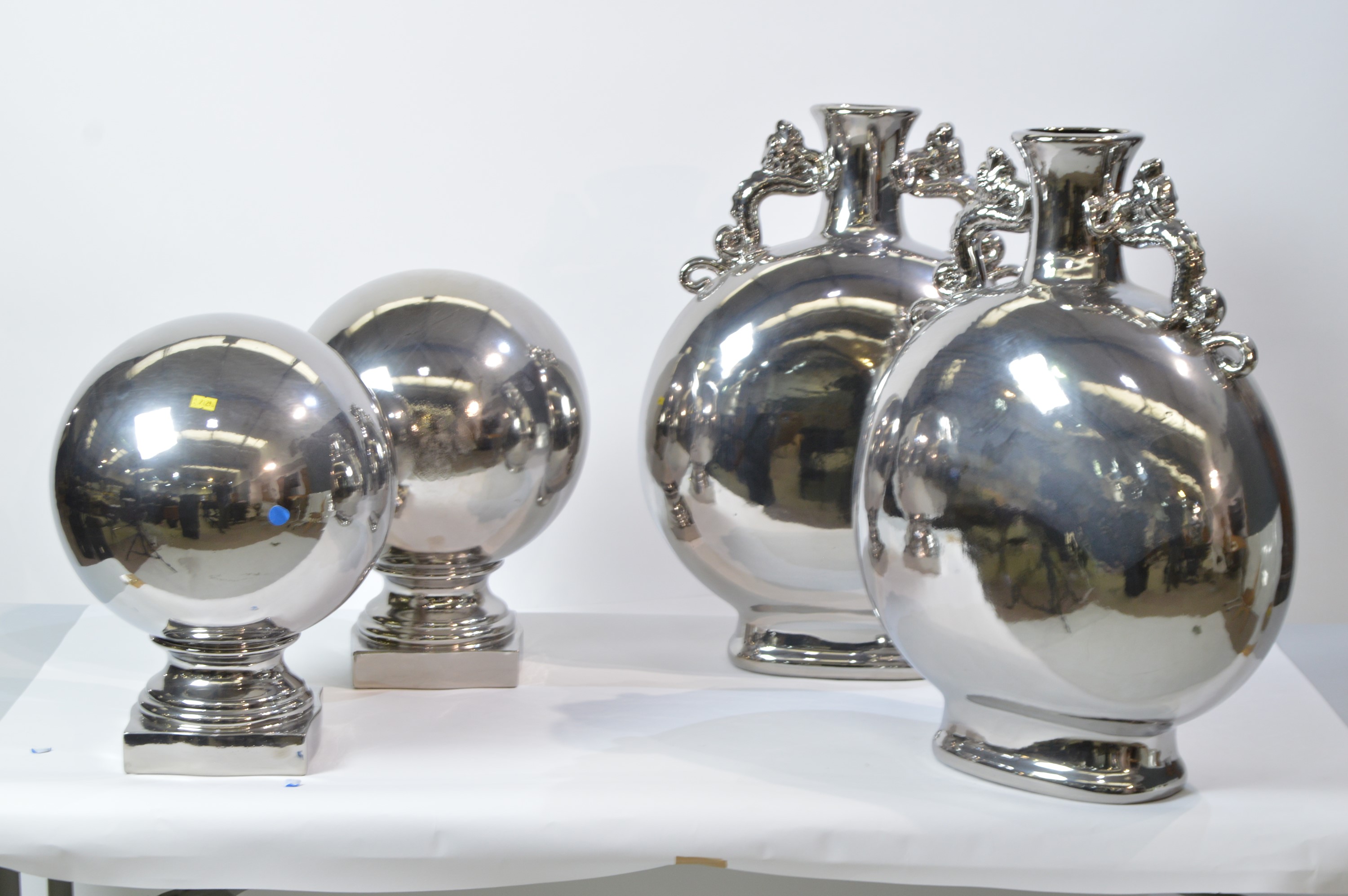 Pair of silvered vases; and a pair of silvered ball ornaments.