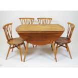 Ercol - model 384 elm drop leaf dining table and four 'Shalstone' oak dining chairs