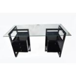 A modern black lacquered and glass desk.