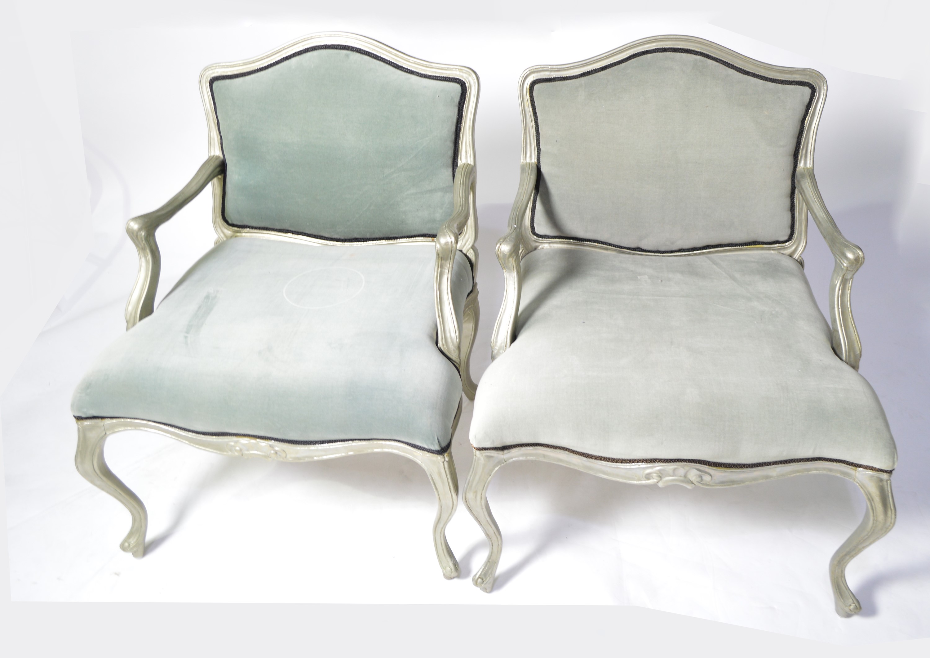 A pair of designer French style armchairs.