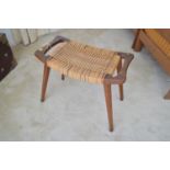 A mid Century teak and woven stool.