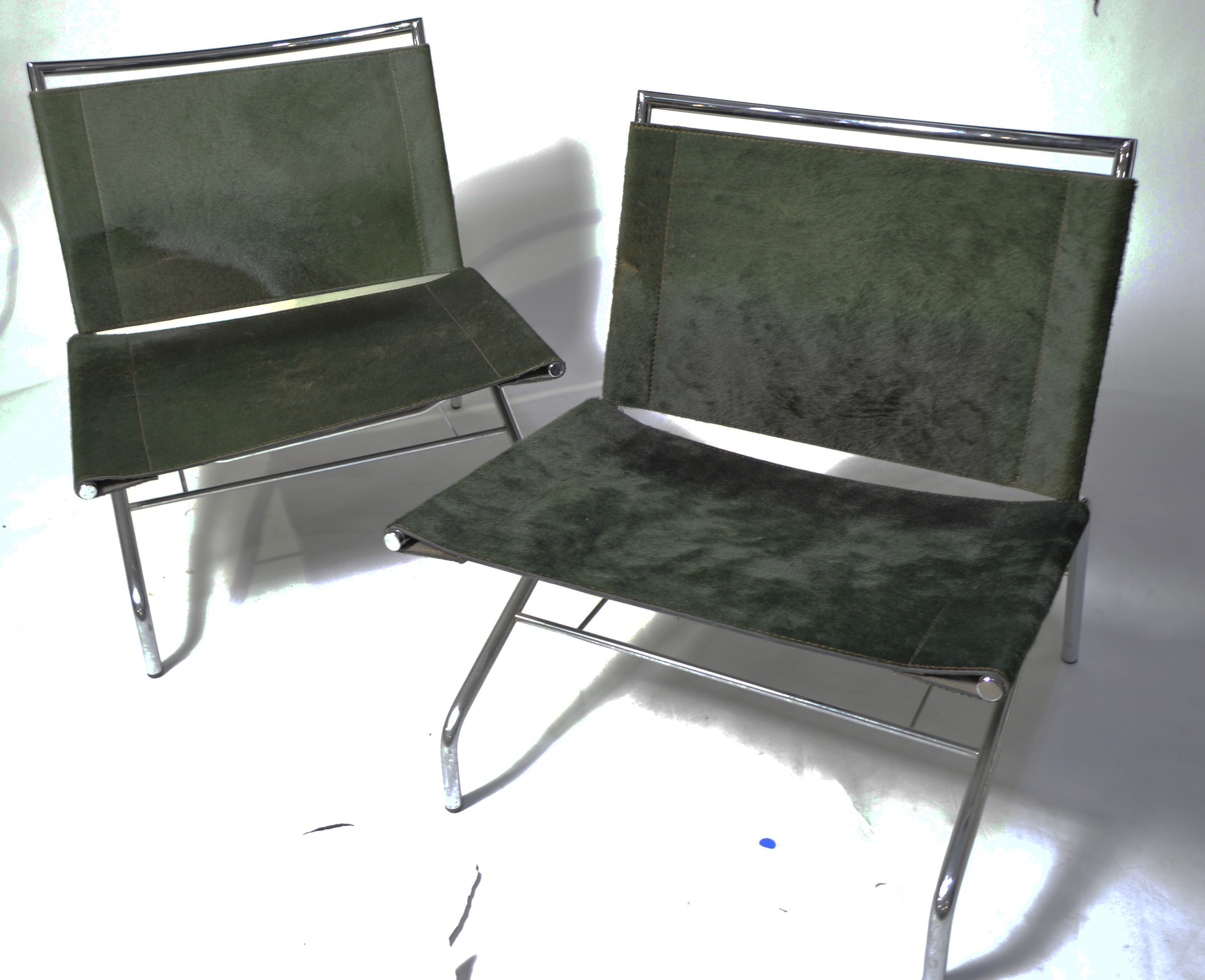 A pair of designer low slung chairs.