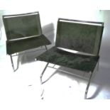 A pair of designer low slung chairs.