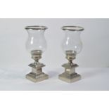 Eichholtz: a pair of glass and metal urn pattern candle stands.