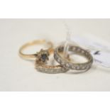 Three white stone set rings.