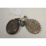 A heart-shaped locket; and two silver oval lockets.