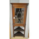 An Edwardian inlaid mahogany corner display cabinet on stand.