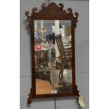 A George III mahogany wall mirror.