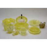 Collection of yellow vaseline glass items.