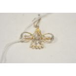 An Edwardian diamond and seed pearl brooch.