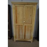 A stripped pine cupboard.