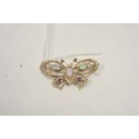 A butterfly gem-set brooch.