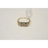 A Three-stone diamond ring.