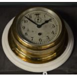 A ship's brass cased wall clock.
