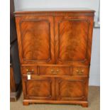 A reproduction mahogany television cabinet.