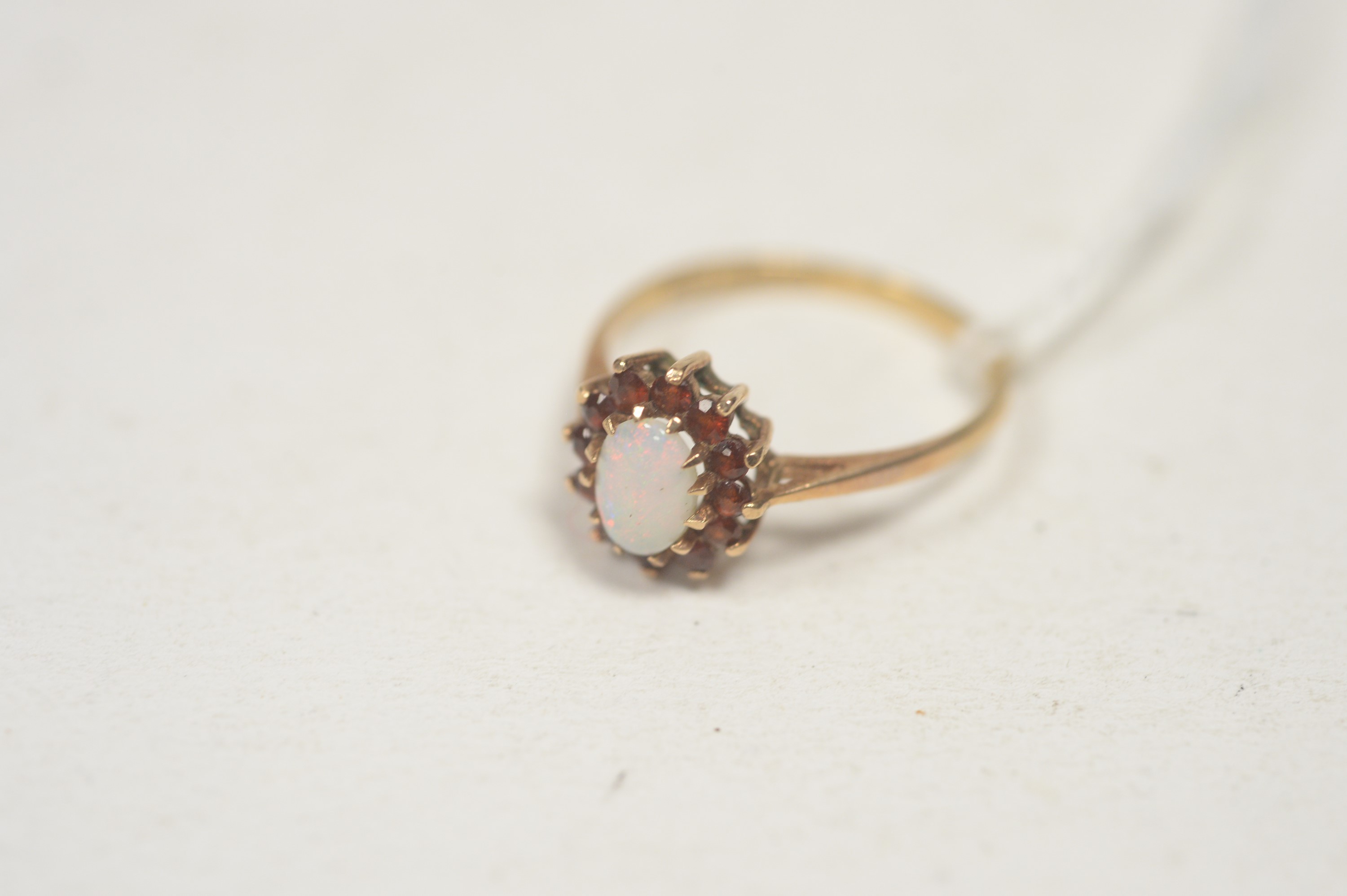 An opal and garnet cluster ring.