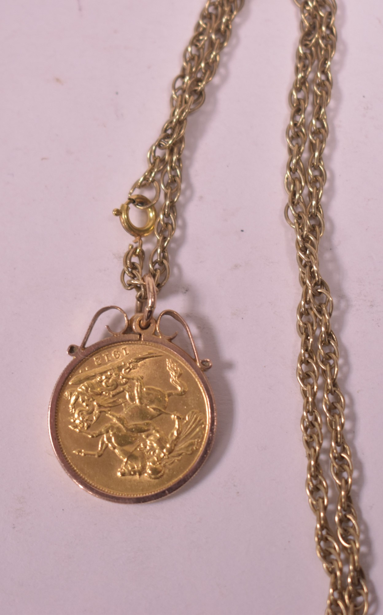 Gold sovereign pendant on chain