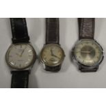 Three steel-cased wristwatches.
