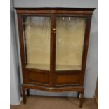 An Edwardian serpentine front mahogany display cabinet.