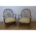 Pair of Ercol dark stained beech armchairs.