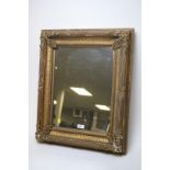 A moulded wood and gilt gesso picture frame mirror, 68 x 49cms.