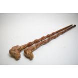 A pair of carved softwood walking sticks