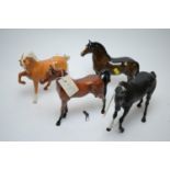 Four Beswick horses.