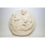 A plaster plaque depicting Madonna, child and infant John the Baptist,