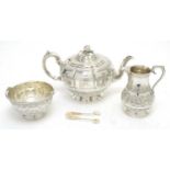 A Victorian silver teapot, with associated sugar basket and milk jug; and sugar tongs.