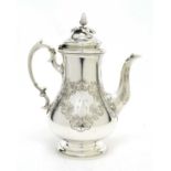 An early Victorian silver coffee pot.