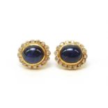 A pair of sapphire and diamond cluster earrings.