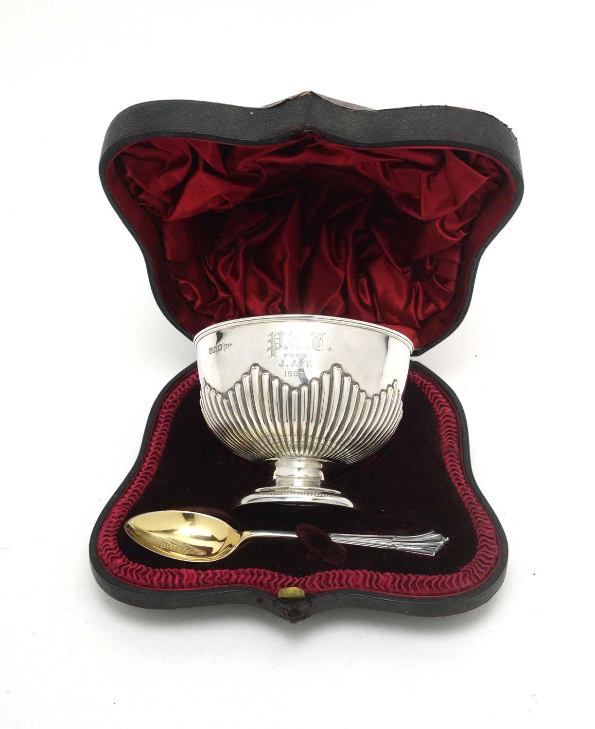 An Edwardian silver sugar bowl and spoon.