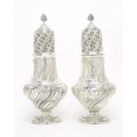 A pair of large Victorian silver casters,