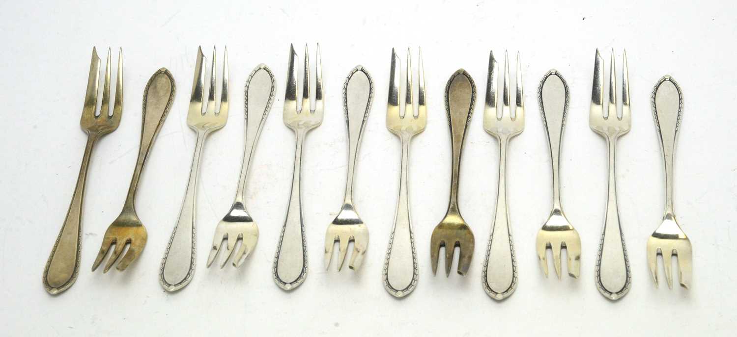 A set of twelve German 800 standard silver cake forks.