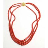 A three row coral bead necklace