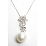 A pearl and diamond pendant