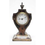 An Edwardian silver and tortoiseshell mantel timepiece.