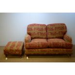 Two-seater sofa and matching footstool.