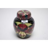 A modern Moorcroft ginger jar and cover, with floral decoration on blue ground, boxed.