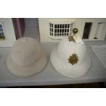 Two military pith helmets.