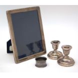 Silver photo frame, dwarf candlesticks and a plated napkin ring