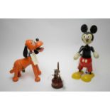 A pair of painted wooden Walt Disney money boxes, in the form of Mickey Mouse and Pluto, with