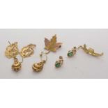 Gold earrings, brooch and charm