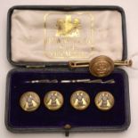 Set of four buttons; and a Royal Navy mounted button brooch.