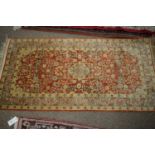 A Persian silk carpet