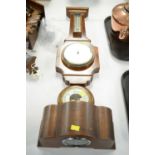 An aneroid barometer in walnut case with thermometer; a small circular aneroid barometer; and a
