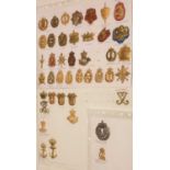 A collection of 42 Danish cap badges.