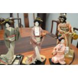 Four modern Japanese costume dolls.